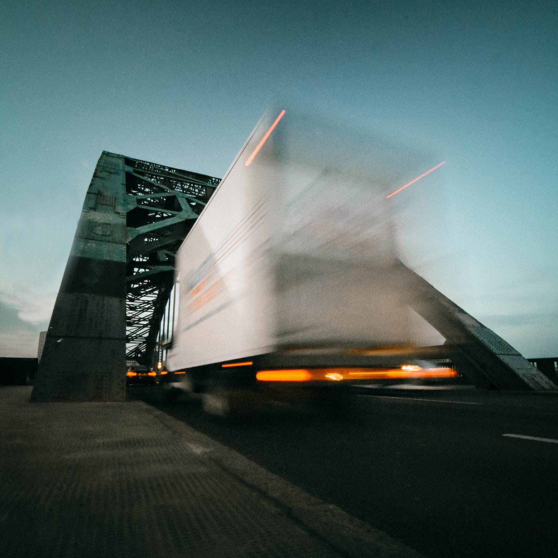 time lapse photography of truck going on bridge